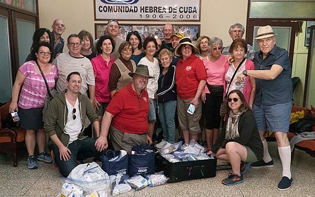 Seth Derma, back row, fourth from the left, with volunteers and donated medical supplies.