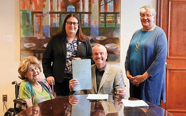 Babs Siperstein, at left, with Gov. Phil Murphy signing the law simplifying the procedure to change gender identity on birth certificates. Also pictured is Army National Guard veteran Jennifer Long, standing at left, and Sue Fulton, head of the Motor Vehicle Commission. Photo courtesy Office of Gov. Phil Murphy