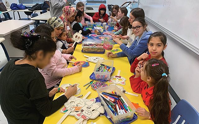 At Temple Emanu-El’s Fun Club, children work on arts and crafts while their parents learn English. (Photos by Johanna Ginsberg)
