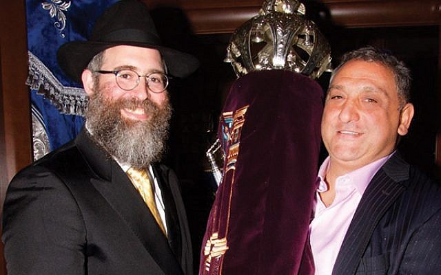 Rabbi Yehuda Spritzer, at left, with Danny Matarese and the Torah scroll dedicated in memory of Susan Barbara Korn Matarese. 
Photo by Ed Hornichter