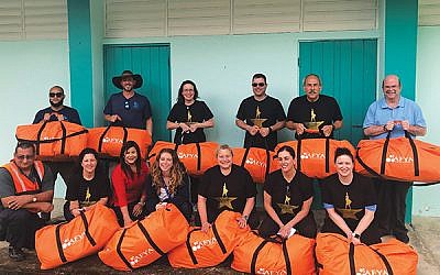 Leslie Dannin Rosenthal, standing, third from left, and her group brought 11 duffel bags filled with medical supplies to give to Puerto Ricans in isolated areas.