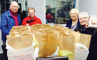 Volunteers prepare Passover bags to be distributed to families and individuals in need.