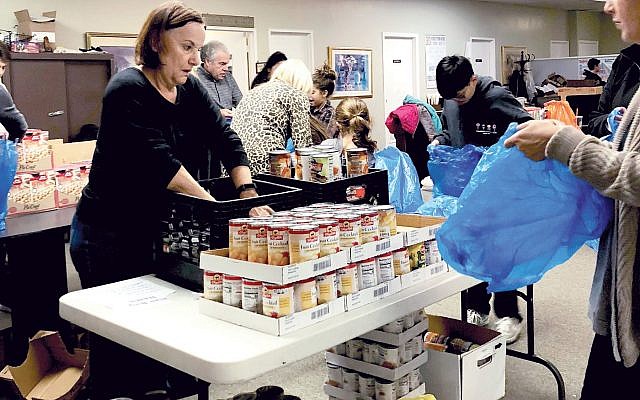 Marlboro Jewish Center congregants collect canned goods for a food drive. Courtesy Marlboro Jewish Center