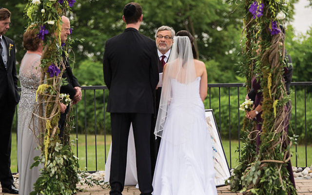 Conservative Rabbi Seymour Rosenbloom officiating at the wedding of his stepdaughter and her fiancé in 2014. He was expelled from the movement for his act. Courtesy of Stefanie Fox via JTA