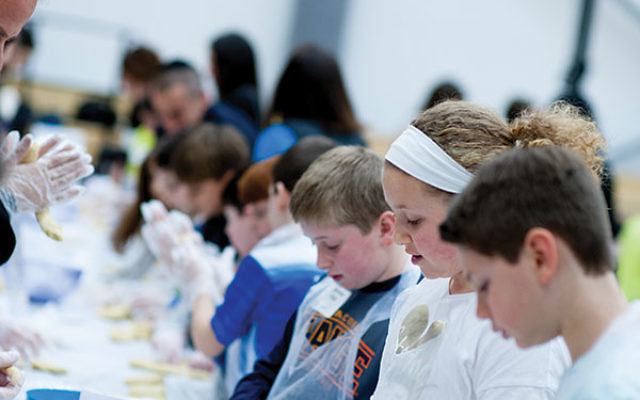 Students learn how to braid the dough.