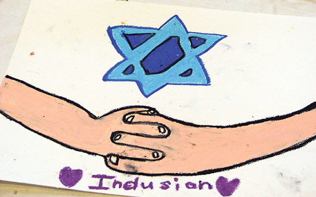 One student at Temple Sharey Tefilo-Israel conveyed the concept of inclusion through clasped hands. One student at Temple Sharey Tefilo-Israel conveyed the concept of inclusion through clasped hands.