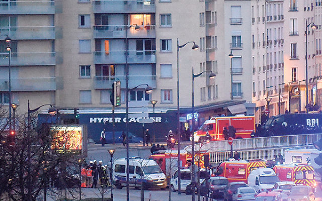 Police arrive at the Hyper Cacher kosher market, where the hostages were being held, Jan. 9. &nbsp;&nbsp; &nbsp;