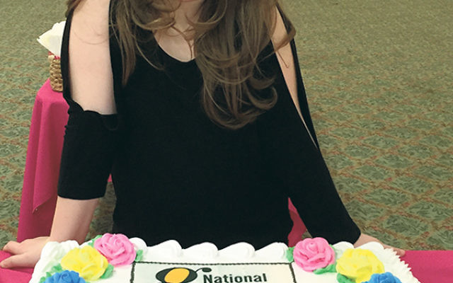 Lindsay Zuckerman displays the cake she shared at the Jan. 31 dance-athon benefit at Pine Brook Jewish Center.