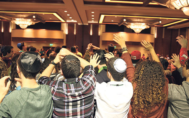 Cheering teens show their spirit at the annual international USY convention in Atlanta.     