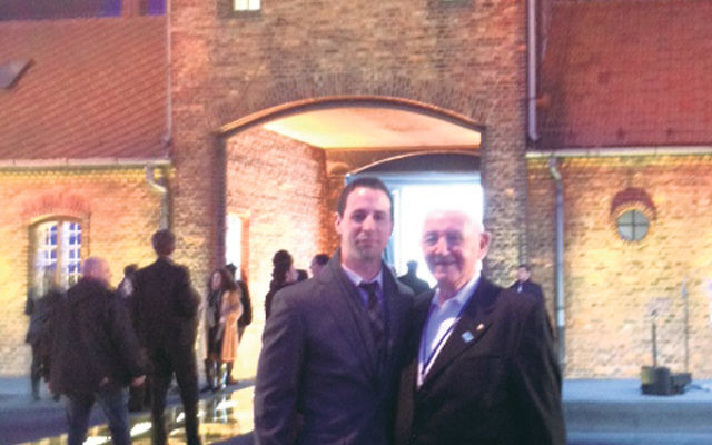 Avi and Cantor David Wisnia in front of the gate to the death camp at Birkenau.     