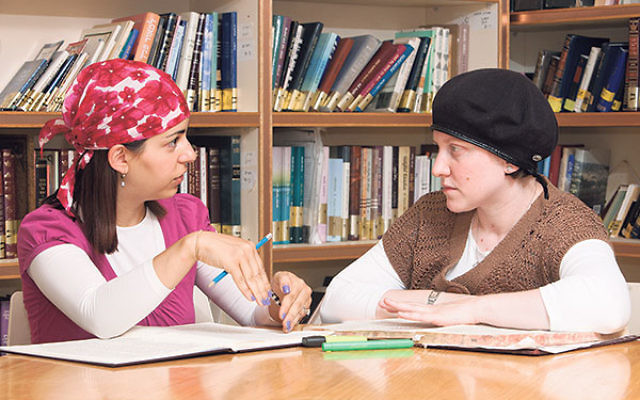 Nechama Price, right, studies with another yoetzet Halacha at Nishmat, the women’s Torah study center in Jerusalem.