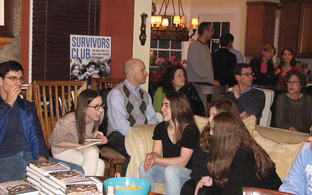 A group of teens and adults gather on April 24 in the North Caldwell home of Lori and Keith Wolf to hear Lori’s father, Michael Bornstein, talk about his childhood during and after the war. Photos by Johanna Ginsberg