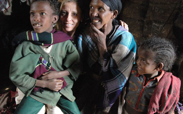Vanguard honoree Sandy Lenger interacts with children four years ago during a national federations’ mission to Ethiopia.