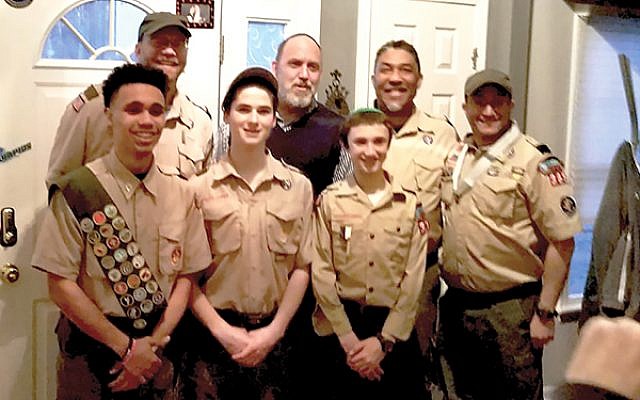 Scouts and leaders pose at Troop 365’s recent Court of Honor. Front, from left, Jared Robertson, Ari Rogers, Michael Spool, and Aaron Spool. Back, from left, Joe Gill, Rabbi Robert Tobin, and Mark Robertson. Photos Courtesy Aaron Spool