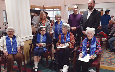 Five residents at Martin and Edith Stein Assisted Living in Somerset celebrated their b’not mitzvah, including Esther Samuels, seated at left, Sophie Melman, Ida Rose, and Sali Frank. Standing, from left, are Jackie Kott, Renee Waller, Cory Heimberg, and Rabbi Bryan Kinzbrunner. Photo by Debra Rubin