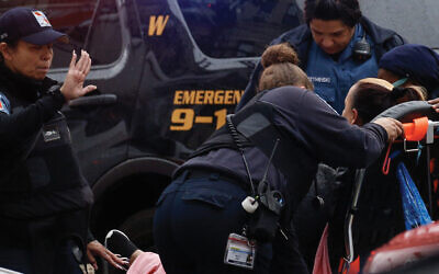 A woman receives medical assistance at the scene of a shooting in Jersey City, Dec. 10. (Kena Betancur/AFP via Getty Images