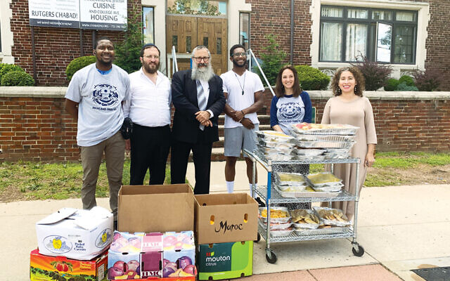 Chabad’s maintenance director, Cardel Birch, left, with Chabad special projects director Rabbi Mendi Pevzner, Chabad House director Rabbi Yosef Carlebach, SHILO outreach director Anthony Gray Jr., Camp Gan Israel director Chayale Shagalow Chazan, and Chabad office administrator Norma Iris Vargas-Greenberg. (Courtesy Chabad)