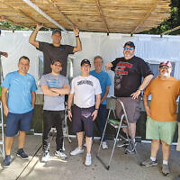 Volunteers from the Men’s Club of Congregation Beth Israel in Scotch Plains built the synagogue’s sukkah on September 19. Throughout the week-long celebration of Sukkot, which began September 20 at sundown, congregants and religious school students were able to eat in the synagogue’s sukkah. (Courtesy CBI)