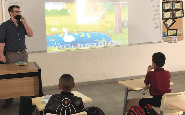 Ezra Brownstein teaches the letter D to children in Nazareth.