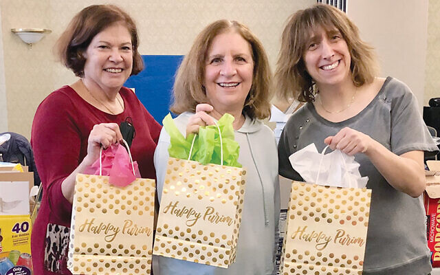 From left: Purim co-chairs Linda Weissbrod and Laura Queller and Nikki Leske, president of Congregation Beth Israel’s sisterhood. (Courtesy CBI)