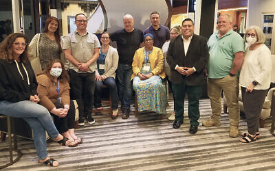 These are some of this summer’s Lerner Fellows; Sarah Coykendall is sitting, second from left, Terrilisa Bauknight, seated in the middle, is wearing a brightly colored dress, and Stanlee Stahl, standing at right, has a mask on.