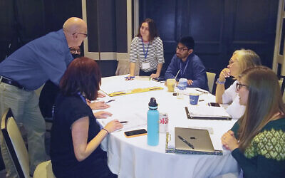 Dr. Buchanan talks to students at a  breakout session at the JFR’s summer institute last month.