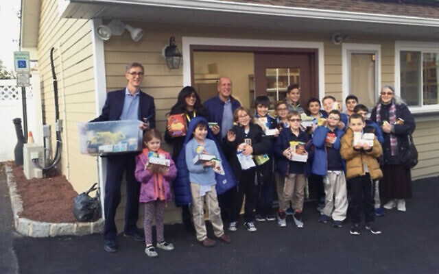 The JFSCNJ Charlotte Shak Food Pantry receives food drive donations from administration, teachers, and students, of the Jewish Educational Center. (Courtesy JFSCNJ)