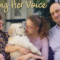 Racheli sits between her parents in the video “Finding Her Voice.”