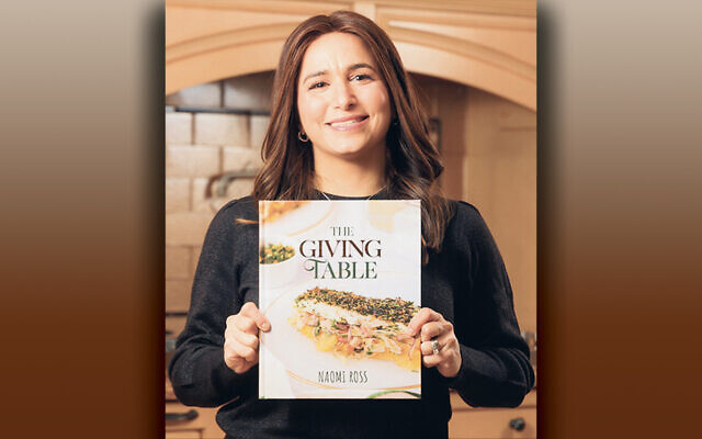Naomi Ross holds her new cookbook