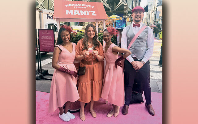 Manischewitz CMO Shani Seidman stands at the Manischewitz MANI’z black and white and pink and white cookie kiosk along the Marvelous Mile for the Marvelous Mrs. Maisel’s send- off. She’s with a group of brand ambassadors who staffed the booths.