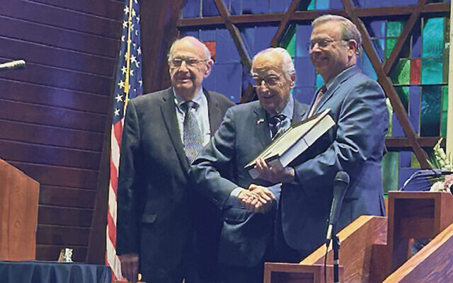 Arthur Barchenko, left, with Rep. Bill Pascrell, handing a flag from Congress to Rabbi Brian Beal. It will hang in the Dresner Library.