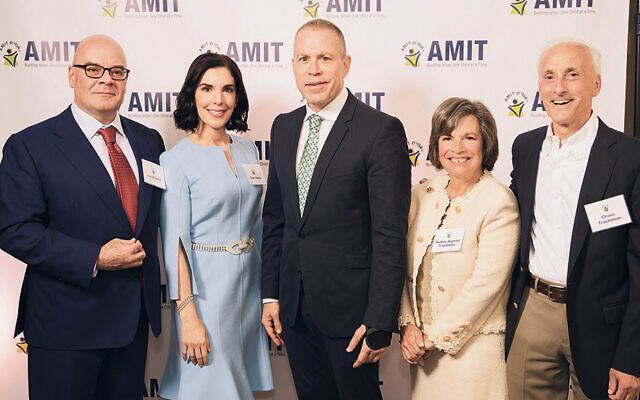 From left, Jacob M. Safra, Shari Safra, Ambassador Gilad Erdan, Audrey Axelrod Trachtman, and Chaim Trachtman are at AMIT Children’s annual assembly.