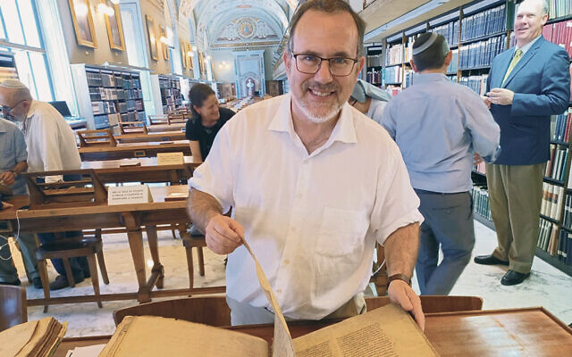 Rabbi Fine turns the pages of a Talmud manuscript. (© 2023 Biblioteca Apostolica Vaticana)