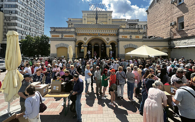 Ukrainians gather outside Rabbi Azman’s shul — the Brodsky Synagogue in Kyiv — as they wait for aid.