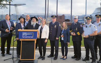 Sarah McCain, who ran the program, is in the middle. From left, Rabbis Avremy Kanelsky and Mordechai Kanelsky are surrounded by Port Authority of New York and New Jersey police and employees. (Courtesy Bris Avrohom)
