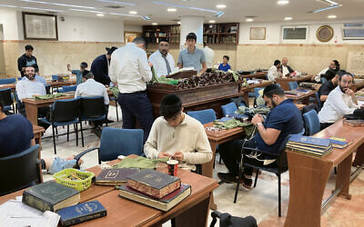 Yeshiva students tie the tzitzit strings.