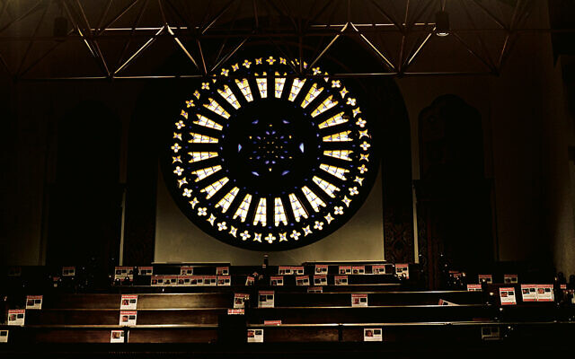 B’nai Jeshurun’s massive rose window overlooks pews with kidnapped posters taped to them.