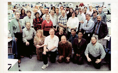 The Star-Ledger nightside staff circa 2002 in its newest newsroom, the third since Jon Lazarus joined the paper in 1967. Silver-haired Jon is in the back row, the second full face from the right.