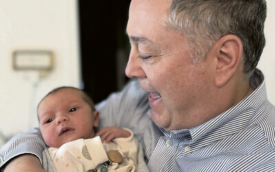 Mr. Fingerman cuddles baby Chaya Sarah.