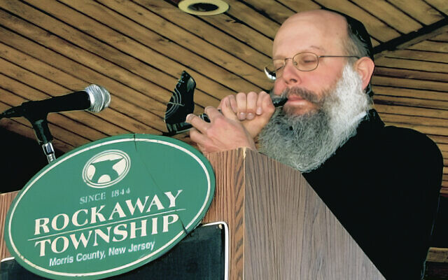 Rabbi Asher Herson blows the shofar at a pre-Rosh Hashanah municipal gathering in Rockaway Township Rabbi Asher Herson blows the shofar at a pre-Rosh Hashanah municipal gathering in Rockaway Township