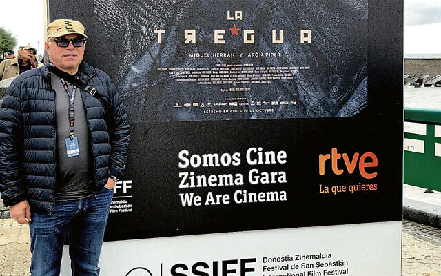 Alexander Smukler stands outside a movie poster in San Sebastian.