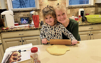 The author and her granddaughter bake challah together.