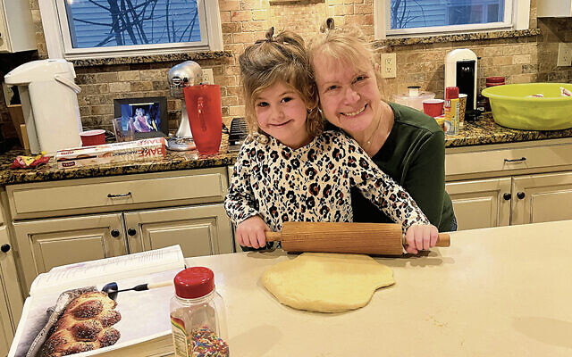 The author and her granddaughter bake challah together.