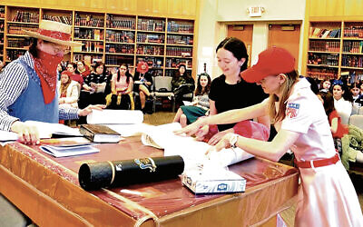 From left, Ann Shinnar, Nesya Bayewitz, and Tirza Bayewitz lead a women’s morning megillah reading at Congregation Rinat Yisrael. From left, Ann Shinnar, Nesya Bayewitz, and Tirza Bayewitz lead a women’s morning megillah reading at Congregation Rinat Yisrael.