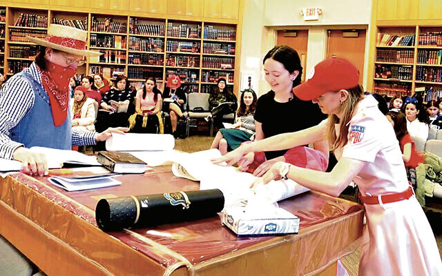 From left, Ann Shinnar, Nesya Bayewitz, and Tirza Bayewitz lead a women’s morning megillah reading at Congregation Rinat Yisrael. From left, Ann Shinnar, Nesya Bayewitz, and Tirza Bayewitz lead a women’s morning megillah reading at Congregation Rinat Yisrael.