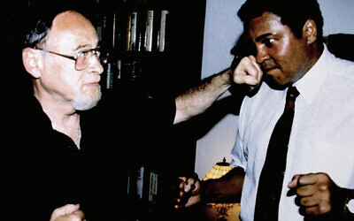 Jerry  pretend punches Olympic gold medalist and three-time heavyweight champion Muhammad Ali.