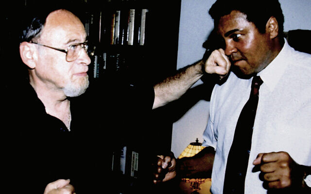 Jerry  pretend punches Olympic gold medalist and three-time heavyweight champion Muhammad Ali.