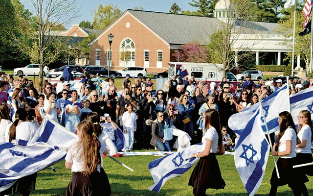 At the celebration last year, girls danced with Israeli flags.