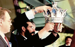 Bruno Bieler and Rabbi Mordechai Weiss place the silver crown on the new sefer Torah in 1995. (All photos courtesy Tzivia Bieler)