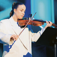 Agam Berger survived Hamas; here, she plays the violine.